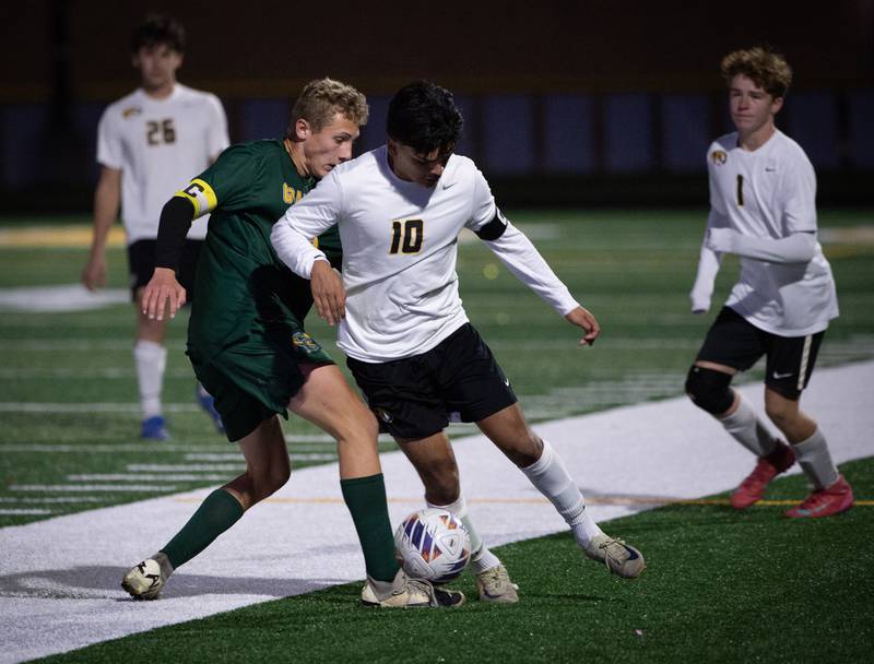 Herscher's Luis Parra controls the ball as Coal City's Luke Munsterman, left, challenges in a sectional game on Tuesday, October 28, 2025.