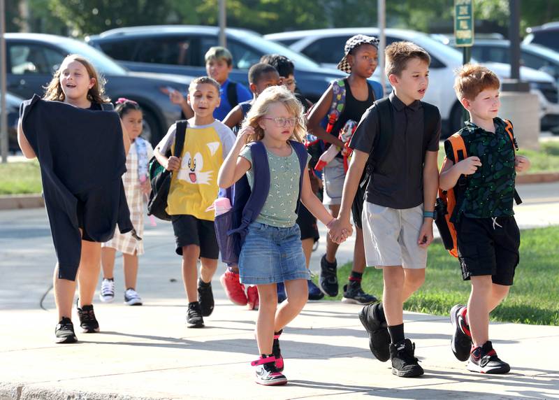 Students arrive for the first day of school Wednesday, Aug. 13, 2025, at Founders Elementary in DeKalb.