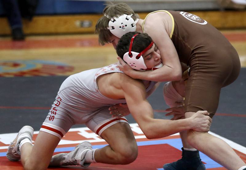 Marian Central's Nicholas Marchese tries to take down Mt. Carmel's Francis Burke in their 126-pound match during a triangle wrestling meet on Saturday Jan. 11, 2025, between Marian Central, Joliet Catholic, and Mt. Carmel at Marian Central High School in Woodstock.