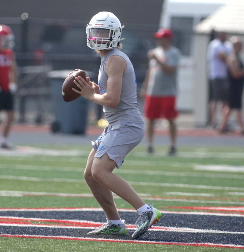 St. Francis quarterback looks to throw the ball during a 7-on-7 football tournament at West Aurora High School on Friday, June 23, 2023.