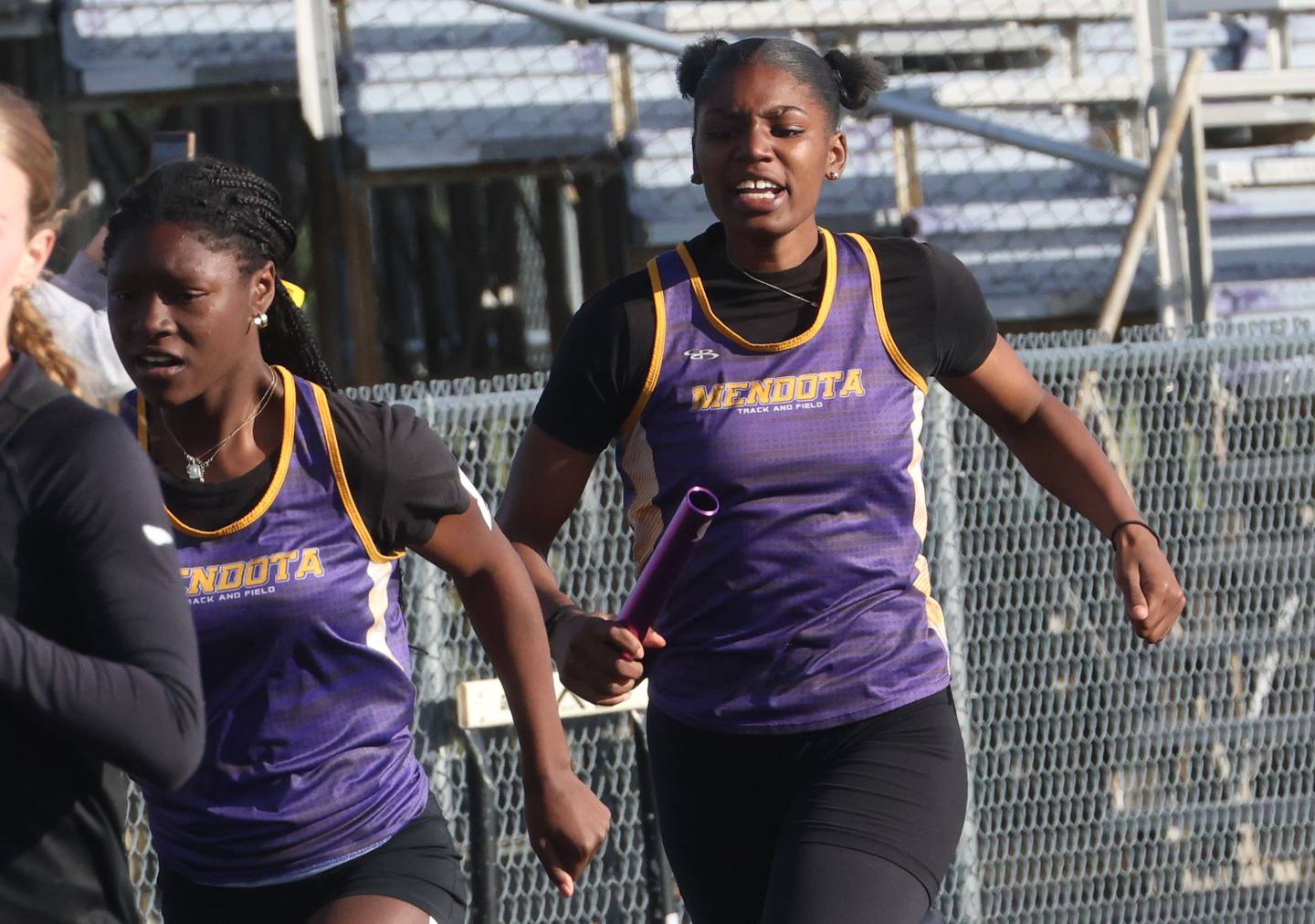 Mendota's Jeniah Francis gets the baton from Mariyah Elam in the 4x200 relay during the Class 2A Sectional track meet on Wednesday, May 13, 2026 in the Jeff Prusator Athletic Complex at Mendota High School.