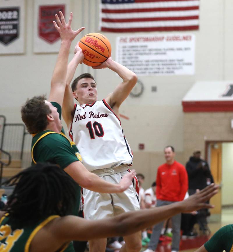 Huntley's Brady Hassels shoots the ball over the defense of Crystal Lake South's Ryan Morgan during a Fox Valley Conference boys basketball game on Wednesday, Dec. 10, 2025, at Huntley High School.