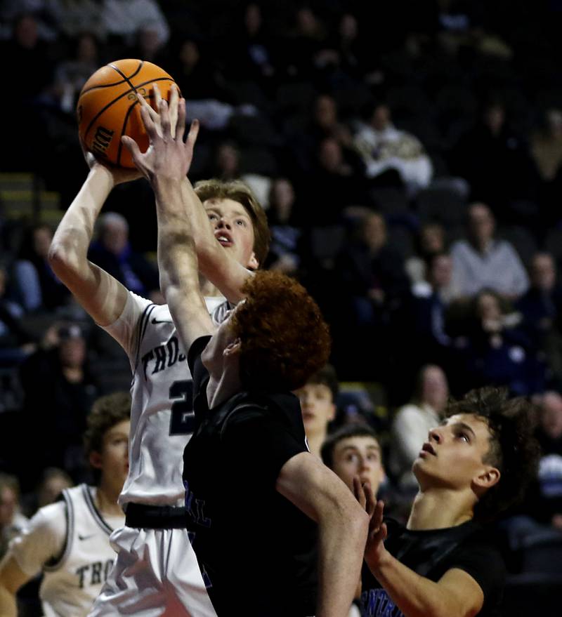 Cary-Grove's AJ Berndt soots the ball over Burlington Central's Patrick Shell during a Fox Valley Conference basketball game on Tuesday, Jan. 14, 2025, at Now Arena in Hoffman Estates.
