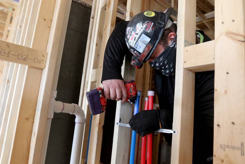 Alex Borisenkov of Norman Mechanical works on installing hot and cold water plumbing in the new Berkshire Johnsburg apartment building on Monday, Feb. 8, 2021 in Johnsburg.  The new Berkshire Johnsburg apartment building will have 68 total units, all of which qualify as affordable housing for seniors.