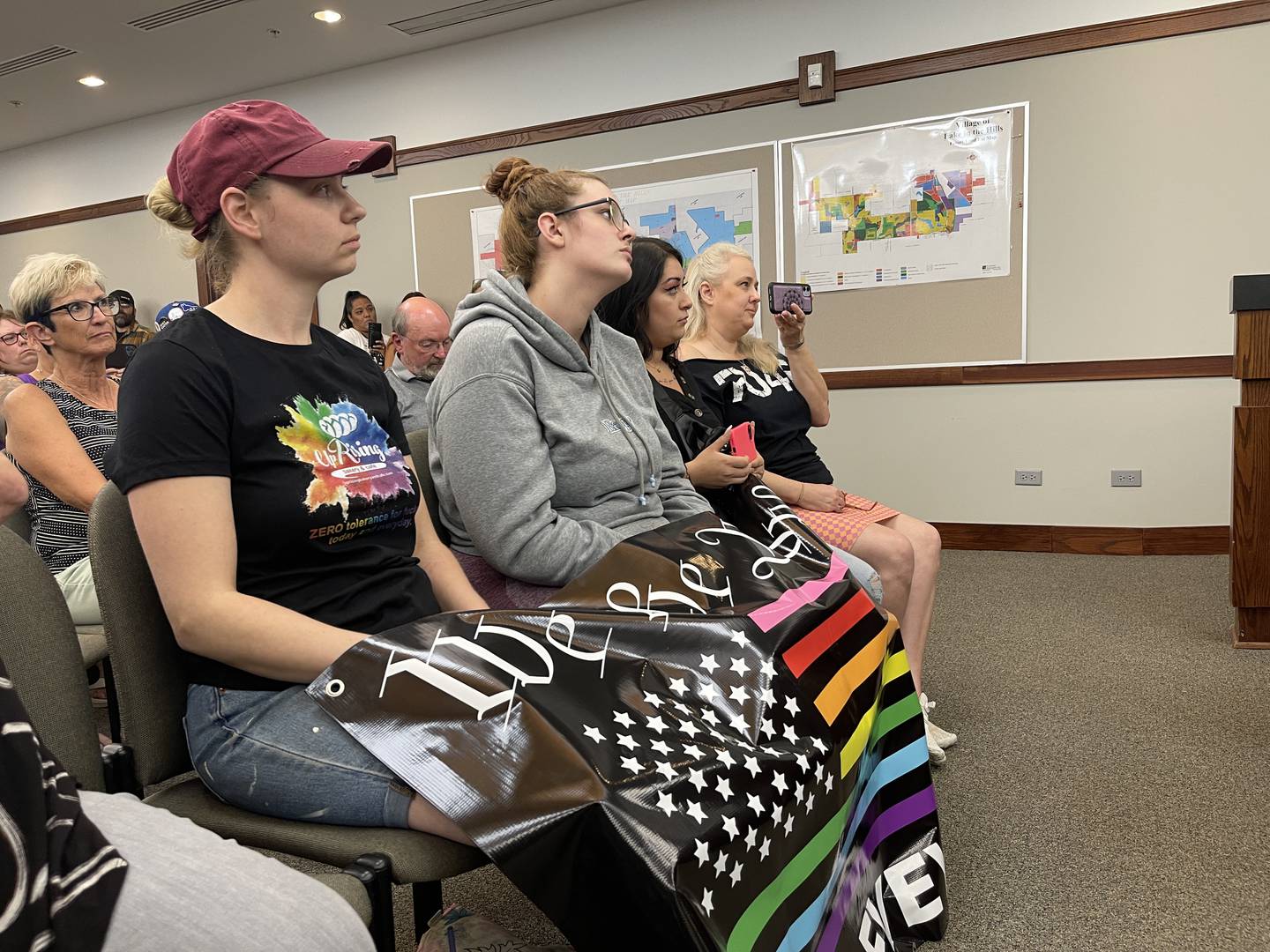 Corinna Sac, owner of UpRising Bakery in Lake in the Hills, listens to comments about her bakery at a Lake in the Hills' Village Board meeting on Tuesday, Sept. 20, 2022. More than 80 people attended the meeting.