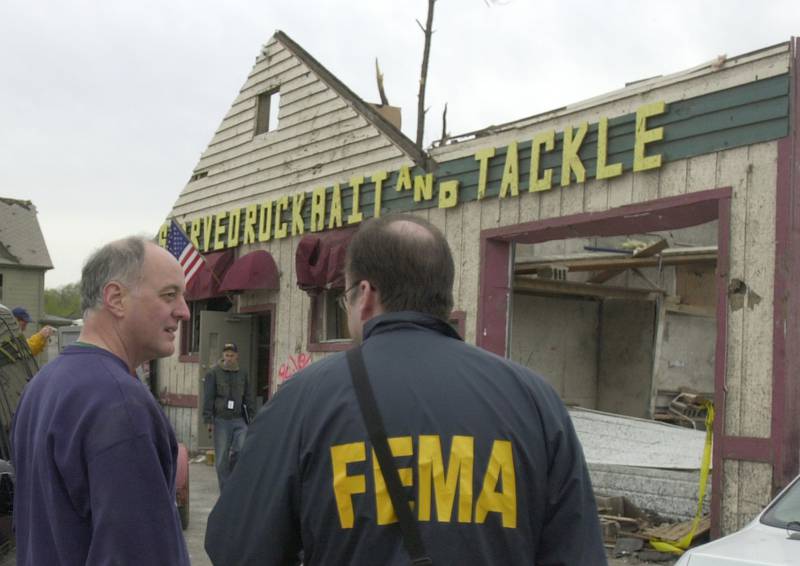 Jim Collins, former owner of Starved Rock Bait and Tackel talks to a representave from FEMA on Tuesday April 21, 2004 in Utica.