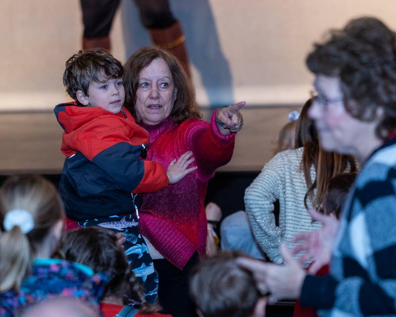 Karen Gress points to dancing performers as she holds Isaac Portilla during performance of "New Year, New Friends" on Saturday, December 27, 2025 at Stage 212 in LaSalle.