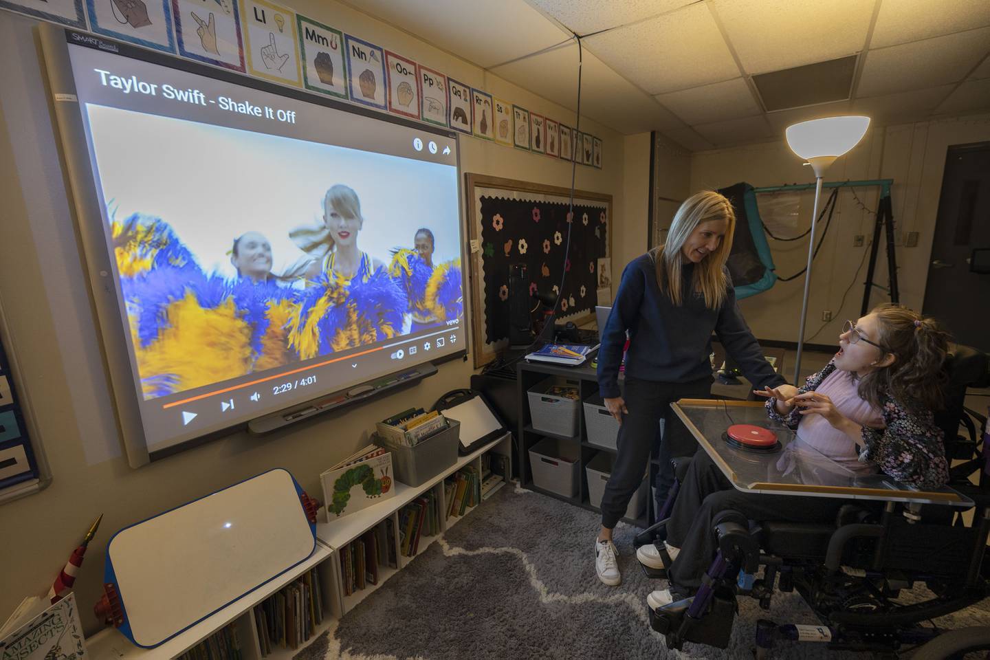 Amy Boss, speech and language pathologist at Reagan Middle School, works with student Addy Weidman Thursday, April 6, 2023. Weidman uses a variety of technology in her learning.