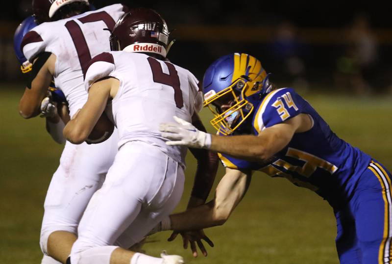 Johnsburg's Blake Hiller tries to tackle Marengo’s Mason Lampe during a Kishwaukee River Conference football game on Friday, Sept. 15, 2023, at Johnsburg High School.