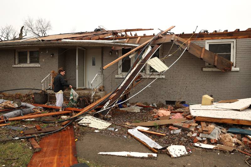 Emily LaVoie surveys the damage to her home along Elmwood Drive in Aroma Township on Wednesday, March 11, 2026, following the March 10 tornado in Kankakee County.