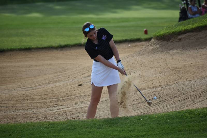 Genoa-Kingston golfer Mikayla Bass escapes the bunker during a home meet on Tuesday, August 20, 2024.