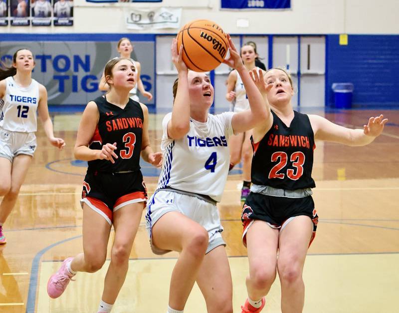 Princeton's Paige Jesse beats Sandwich's Alee Subat (3) and Bailey Freiders (23) in regional semifinal play Tuesday at Prouty Gym. The Tigresses won 50-35.