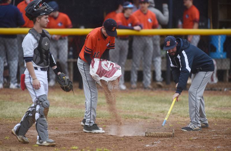 Rain put a damper on Wednesday's Naperville North and Oswego East baseball game in Naperville.