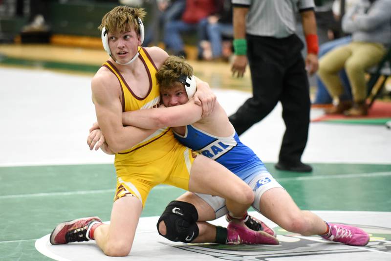 Westmont's Sean Patterson, left, and Central-Iroquois West's Giona Panozzo look the clock in unison as they grapple during the 157-pound third-place match at the IHSA Class 1A Coal City Sectional Saturday, Feb. 15, 2025.