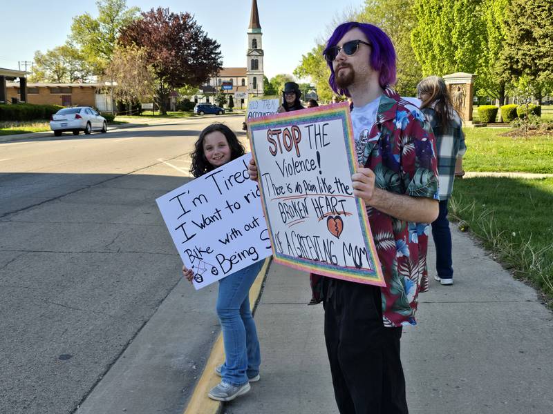 Organizer Noah Girard holds a sign Tuesday, May 6, 2025, at Streator's City Park along with Zeppelin Kissell promoting an end to recent violence in Streator.