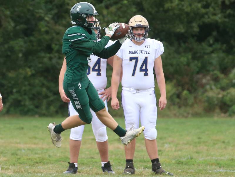 St. Bede's Carson Riva makes a leaping catch with the ball and runs in for the teams only touchdown against Marquette on Saturday, Sept. 28, 2024 at St. Bede Academy.