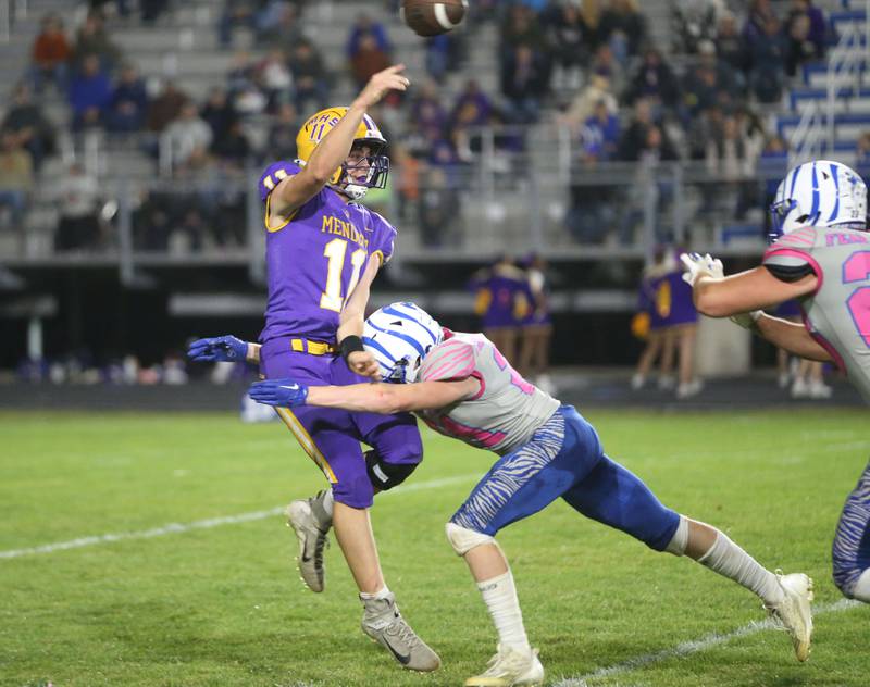 Mendota quarterback Braden Shaw gets a pass off as Princeton's Jace Weyer makes contact with him on Friday, Oct. 10, 2025 on Bryant Field at Princeton High School.