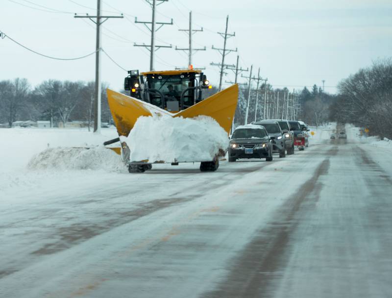 An Illinois Department of Transportation grader uses a side plow to move snow back from the edge of the eastbound lane of state Route 64 on Saturday, Jan. 13, 2024. Crews worked through Friday evening and all day Saturday in anticipation of strong winds, more snow, and sub-zero temperatures forecasted into Sunday.