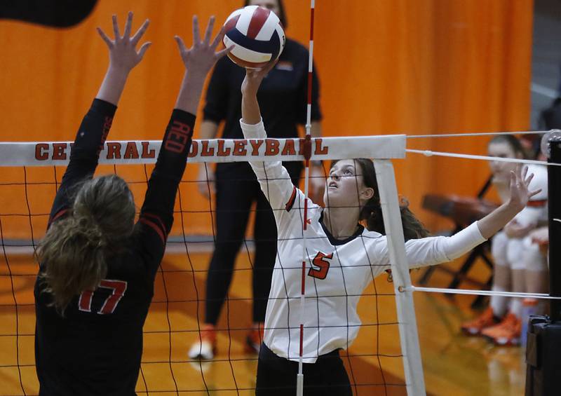 Crystal Lake Central’s Mykaela Wallen, right, tries to hit the ball past the block of Huntley’s Georgia Watson during a Fox Valley Conference volleyball match Tuesday, Aug. 23, 2022, between Crystal Lake Central and Huntley at Crystal Lake Central High School.