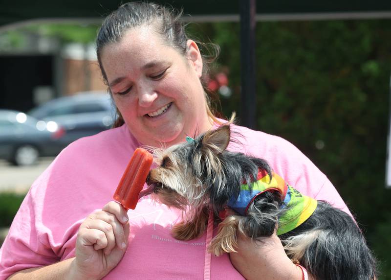 Rachel Jamar Thompson shares her popsicle from the Ms. Mint’s Pop Shop booth with her Yorkshire Terrier Paris Francis during opening day for the DeKalb Farmers Market Thursday, June 1, 2023, at Van Buer Plaza in downtown DeKalb. The Farmers Market is open every Thursday from 10 am to 2 pm through September 21.