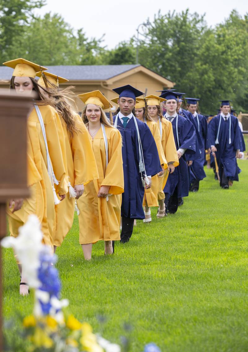 Marquette Academy high school graduates walk onto the field Sunday, May 29, 2022, at Gould Stadium for their commencement ceremony.