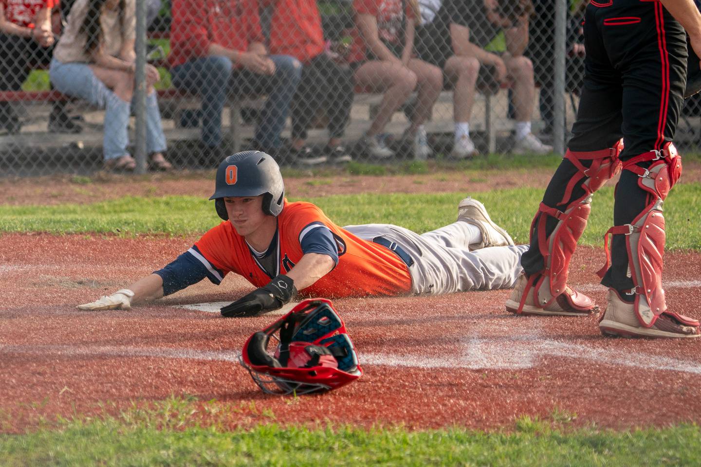 Oswego’s Luke Voelker (19) slides into home to score the go ahead run against Yorkville on a single by Trey Hernandez (not pictured) during a baseball game at Yorkville High School on Monday, May 15, 2023.
