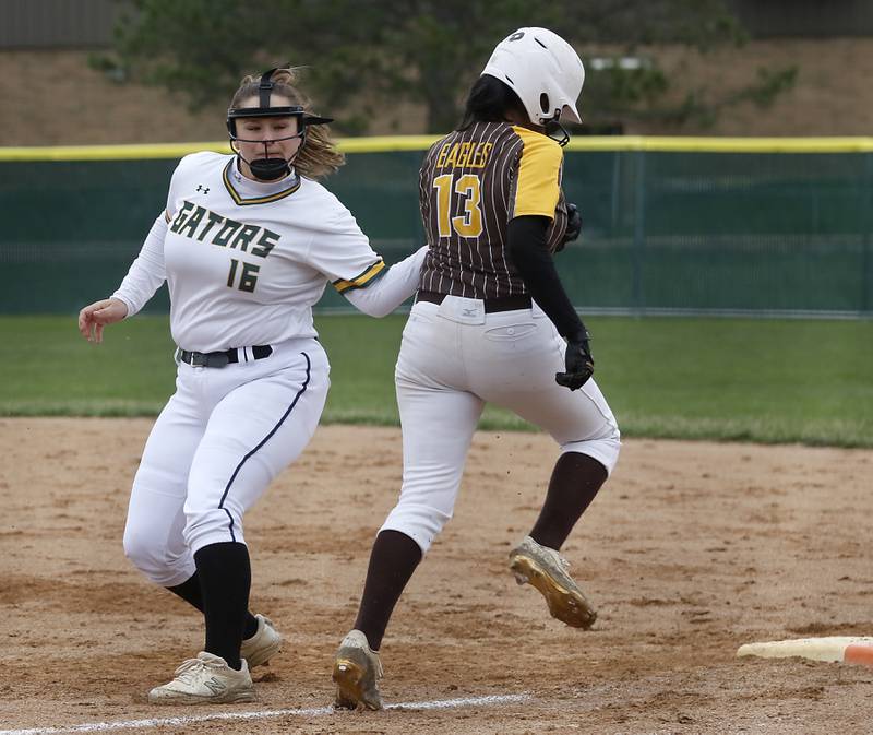 Crystal Lake South's Dana Skorich tags out Jacobs’s Arya Patel as she run to first base during a Fox Valley Conference softball game Monday, April 25, 2022, between Crystal Lake South  and Jacobs at Crystal Lake South High School.