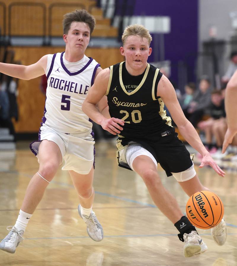 Sycamore's Isaiah Feuerbach drives by Rochelle's Mason Ludwig Friday, Dec. 5, 2025, during their game at Rochelle High School.