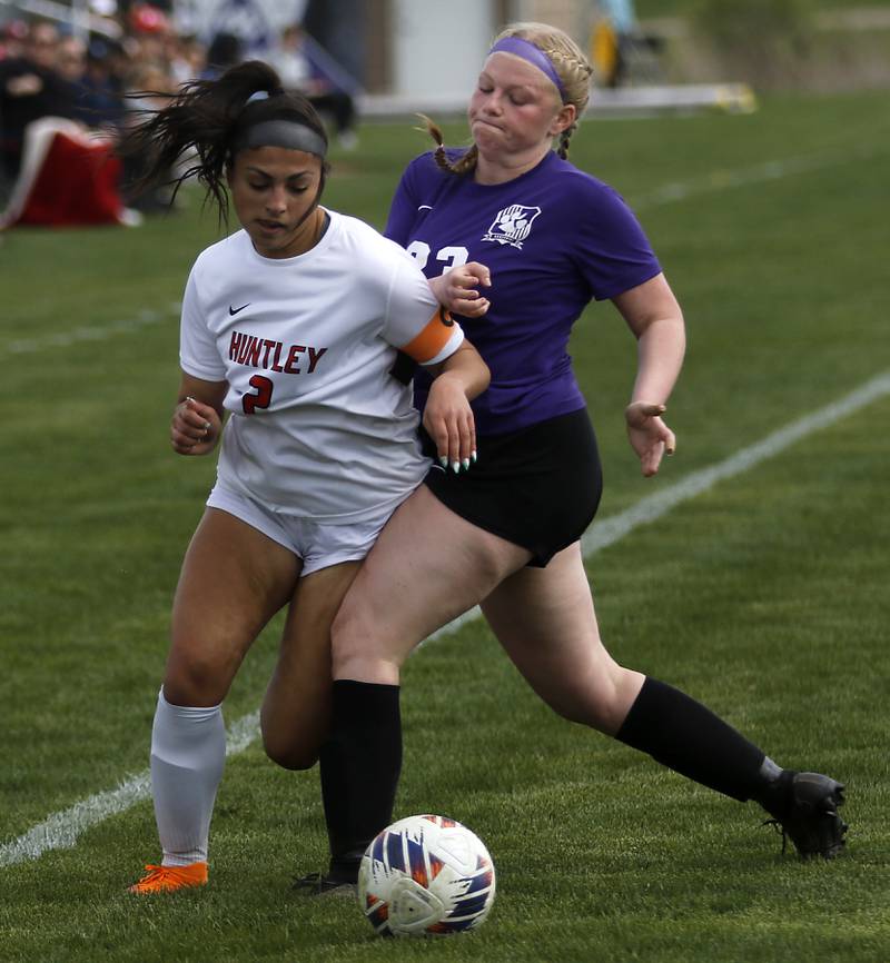 Hampshire's Madison Koth knocks Huntley's Gabi Farraj off the ball during a Fox Valley Conference soccer game on Tuesday, April 23, 2024, at Hampshire High School.