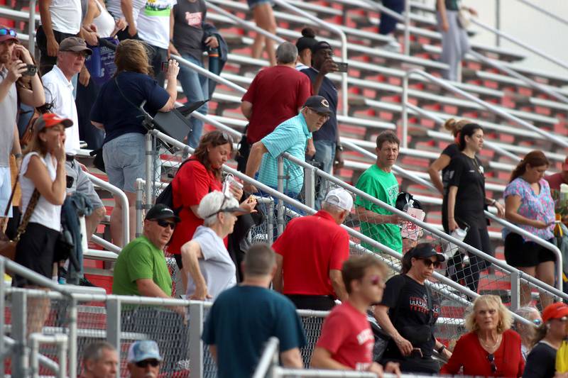 People exit the stadium for a lightning delay in Fox Valley Conference boys track and field meet action at Huntley High School in Huntley on Thursday, May 15, 2025.