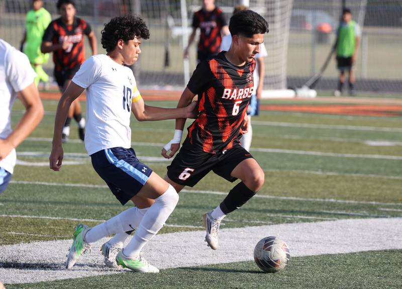DeKalb's Mauricio Jasso (right) controls the ball in front fo Guilford's Luis Rojas during their game Thursday, Sept. 18, 2025, at Dekalb High School.
