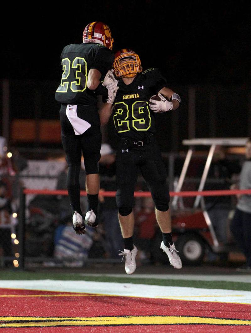 Batavia's Thomas Stuttle (left) and Matthew Huizinga celebrate Huizinga's touchdown on Sept. 30 during a home game against Geneva. The Bulldogs won 21-7 for their sixth straight win in the rivalry.