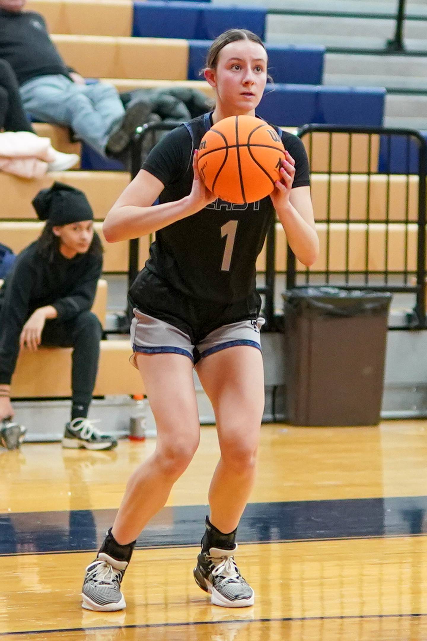 Oswego East's Aubrey Lamberti (1) spots up for a three pointer during a basketball game against Oswego at Oswego High School on Wednesday, January 22, 2025.