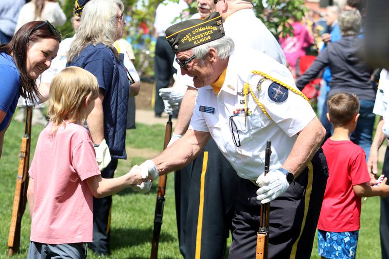 Michael Reilly, 8, of Woodstock greets VFW Post 5040 Jr. Vice Commander Fred Strauss after a Memorial Day service in downtown Woodstock on Monday, May 26, 2025.