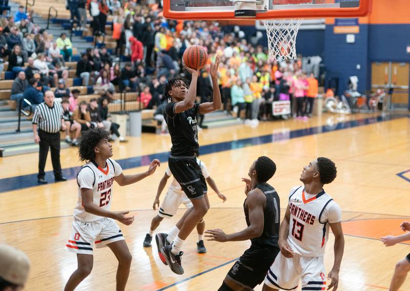 Oswego East's Mason Lockett IV (2) shoots the ball in the post against Oswego during a basketball game at Oswego High School on Tuesday, Dec 12, 2023.