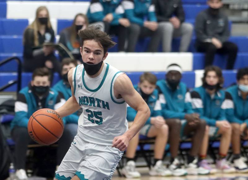 Woodstock North’s Braden Luschei moves the ball against Wheaton North during MLK Tournament action at Burlington Central High School Saturday morning.