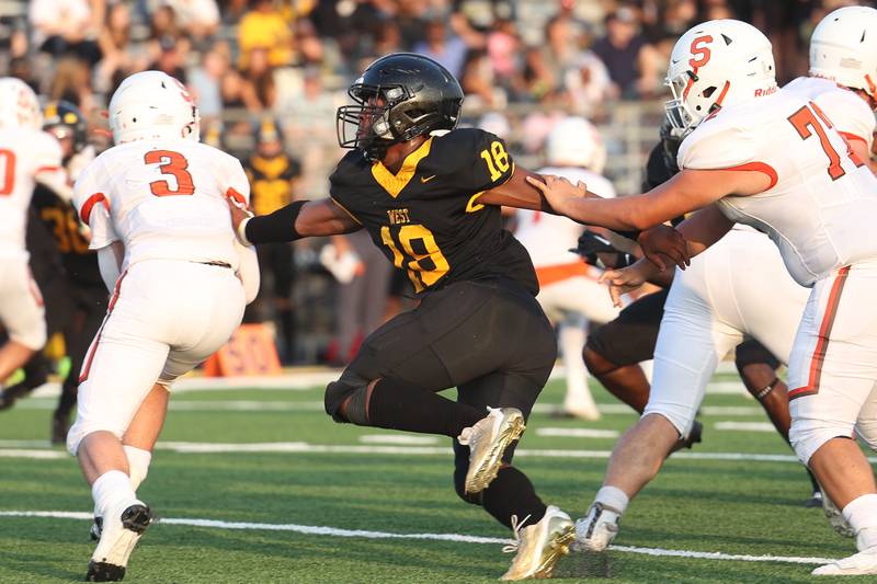 Joliet West’s KeShawn Wiley brings down Shepard’s Anthony Loughran for a loss on Friday, Aug. 25, 2023 in Joliet.