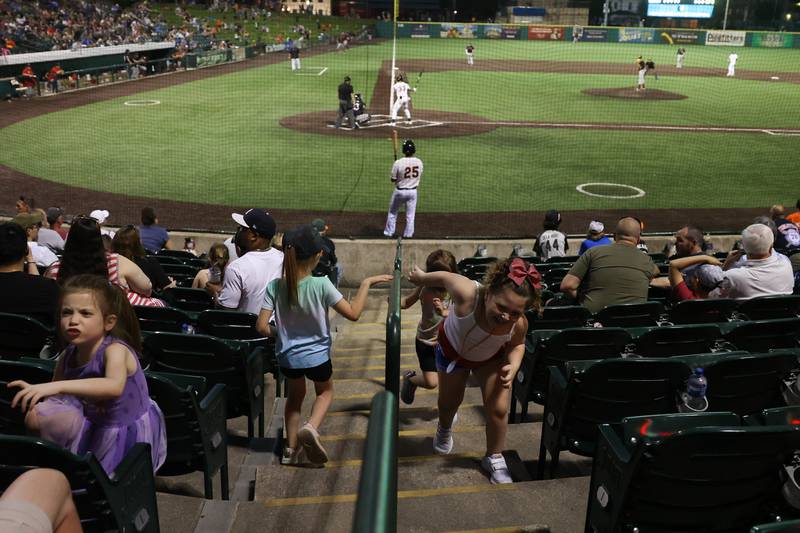 Kids play in the aisle during the Joliet Slammers game against the Ottawa Titans at the home opener at DuPage Medical Group Field. Friday, May 13, 2022, in Joliet.