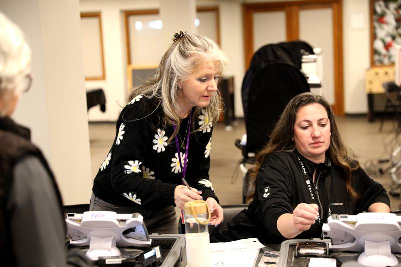 Election judges Cindy Leidig (left) and Danielle Rosenquist assist a voter in the 2025 Consolidated Election on Tuesday, April 1, 2025 at the Baker Community Center in St. Charles.