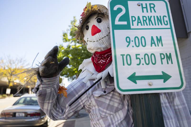 A classic scarecrow built by Dixon Country Dancers keeps track of the downtown.