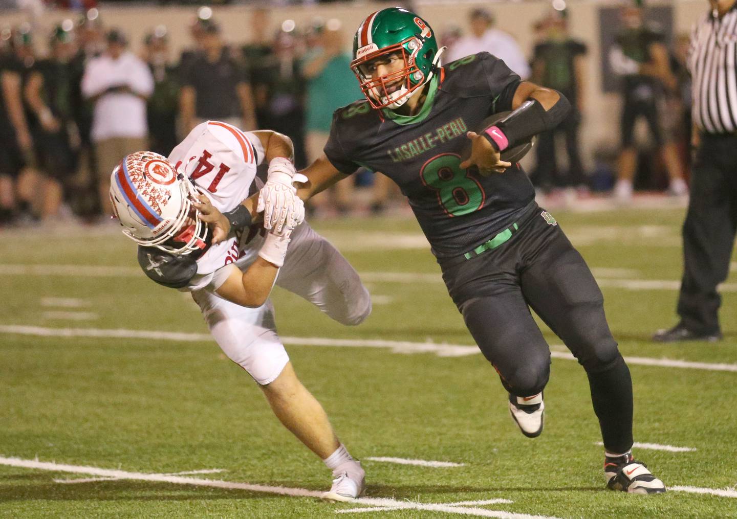 L-P quarterback Marion Persich stiff arms Ottawa's Archer Cechowiz on Friday, Oct. 3, 2025 at Howard Fellows Stadium.