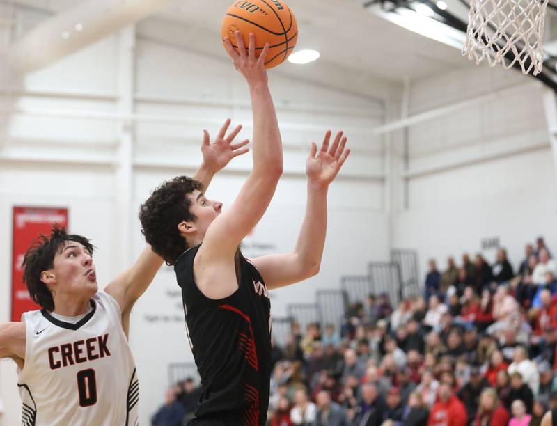 Woodland's Brezdyn Simons eyes the hoop after getting around Indian Creek's Cooper Rissman during the Class 1A Sectional Semifinal game on Wednesday, March 4, 2026 at Amboy High School.