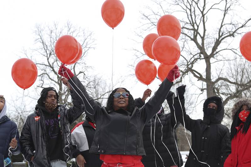 Nicole Lurry, widow of Eric Lurry, who died while in police custody last year, releases red balloons in his honor on Friday, Jan. 29, 2021, at Elmhurst Cemetery in Joliet, Ill. Friends and family held a vigil on the one year anniversary of the death of Eric Lurry.