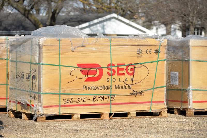 Solar panel materials wait to be loaded onto the roof of Polo Community High School on Saturday, March 2, 2024.