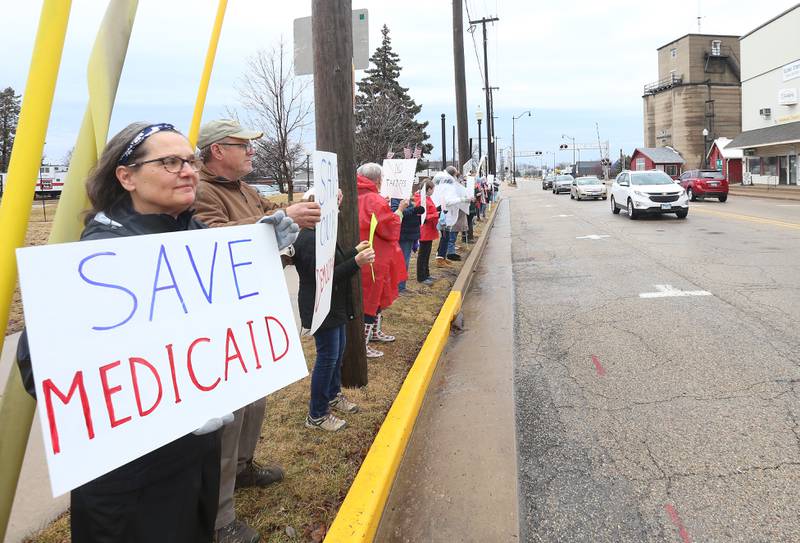 Annie Nicholas holds a sign that reads "Save Medicade" during a March 4 Democracy on Tuesday, March 4, 2025 at Rotary Park in Princeton. Participants brought signs to feature issues of concern for the county, state and country. The event was sponsored by concerned citizens of Bureau County.