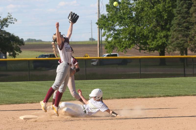 St. Bede's Leah Griggs slides safely into second base as the ball sails over the head of Illinois Valley Central's Joharah Boze during the Class 2A Regional final on Friday, May 23, 2025 at St. Bede Academy.