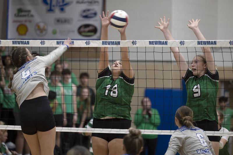 Newman’s Kennedi Shippert spikes against Rock Falls’ Ari Reyna (left) and Kayla Hackbarth Monday, Oct. 28, 2024, during regional play at Newman.