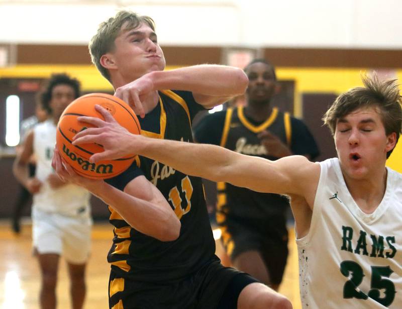 Jacobs’ Carson Goehring, left, drives as Grayslake Central’s Carson Woods defends in varsity boys basketball Hinkle Holiday Classic action on Tuesday, Dec. 23, 2025, at Jacobs High School in Algonquin.