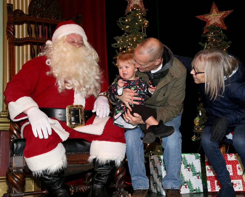 Gregg and Colleen Fuja (far right) bring granddaughter Wrenley Kaufman to see Santa at A Merry Little Sandwich Christmas on Saturday, Dec. 7, 2024.