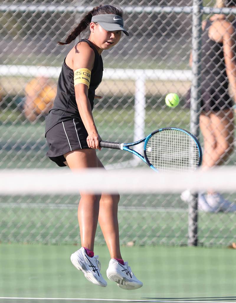 Sycamore's Elizabeth Kleckner hits a backhand during her match against DeKalb's Aubree Judkins Monday, September 19, 2022, at Sycamore High School.